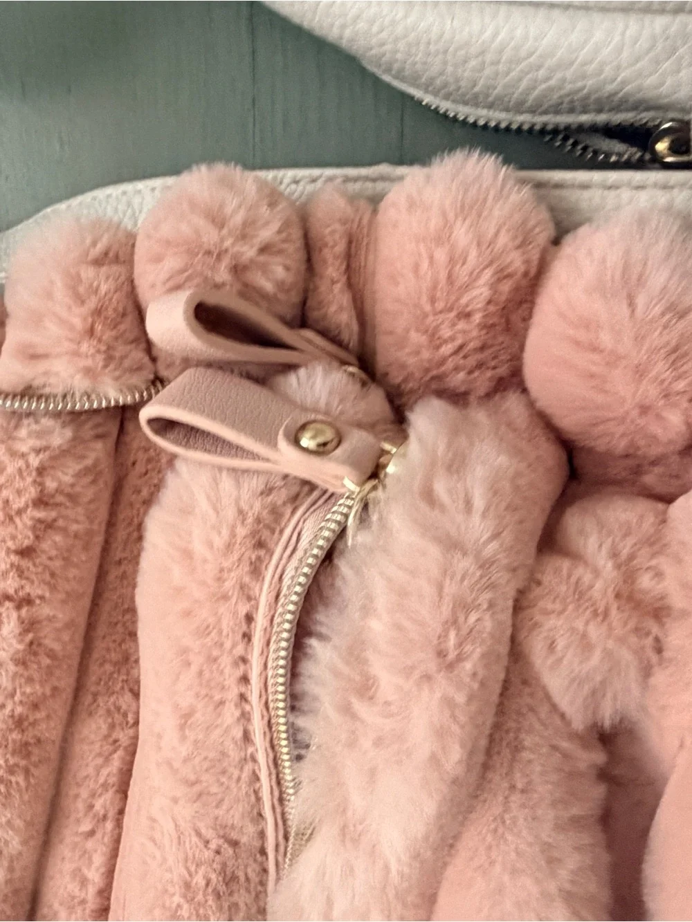 Two cute mini backpacks, one pink fuzzy, one white